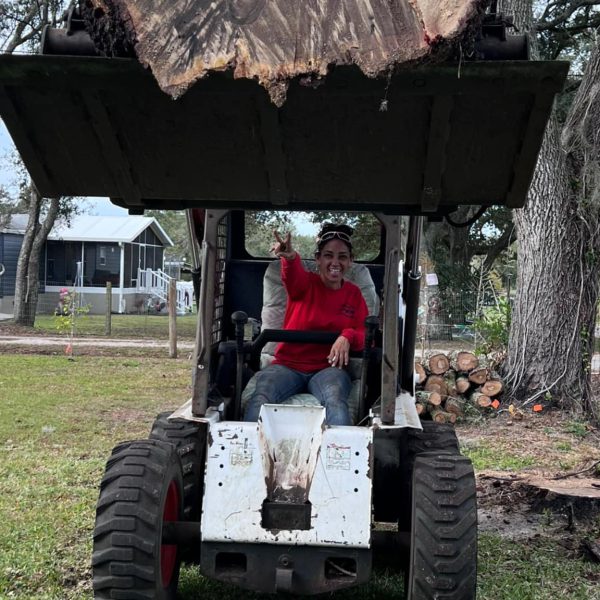 owner of long branch tree service on a skid steer